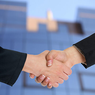 handshake with building in background