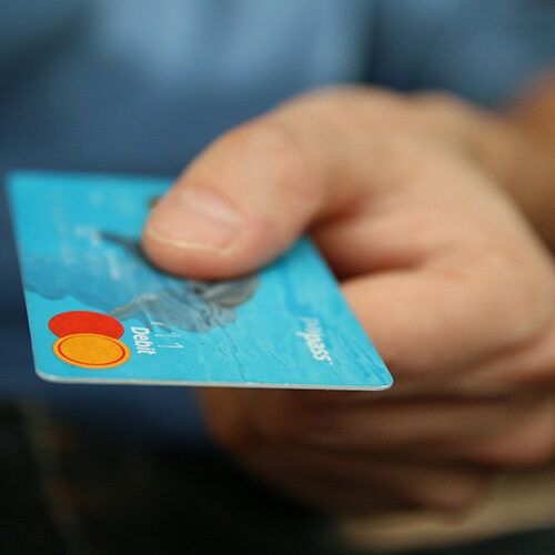 closeup of hand with credit card in it