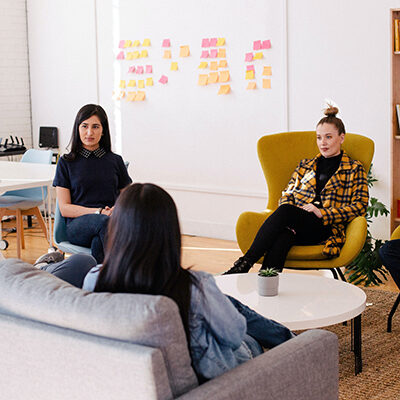 women sitting in chairs in discussion