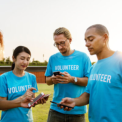 volunteers in group looking at phones