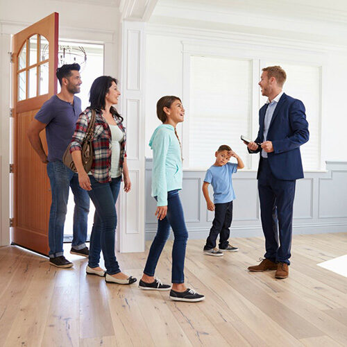 Realtor Showing Hispanic Family Around New Home