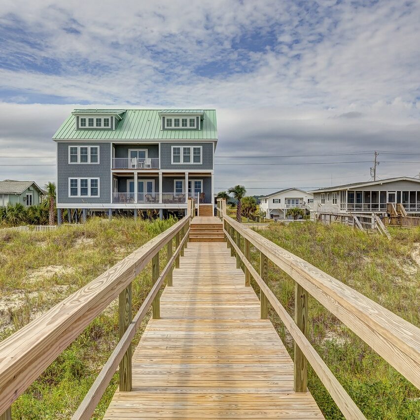 exterior of large home taken from end of boardwalk/dock